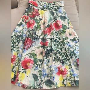 A-line, floral, cotton skirt with belt. Falls mid- calf and is elegant and fresh
